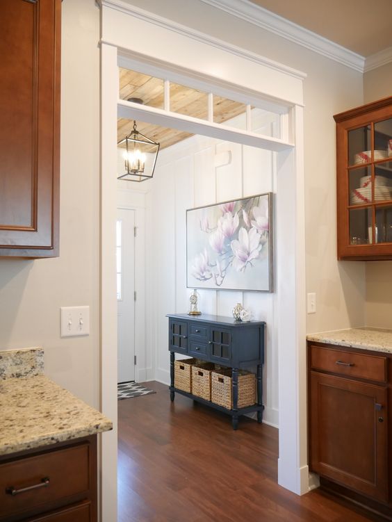 a vintage space with a doorway and a transom window installed here is a beautiful space with plenty of natural light