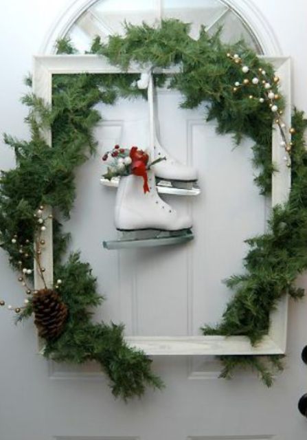 a white frame Christmas wreath with evergreens, pinecones, berries and white skates is a lovely idea for winter