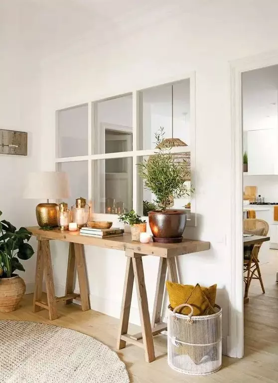 a window from the kitchen and dining room to the living room connects both spaces and gives them both natural light