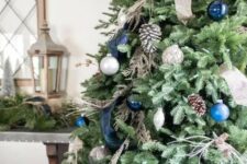 beautiful and natural Christmas tree decor with pinecones, silver, blue and navy ornaments and ribbons is very chic