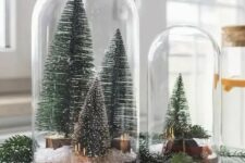 cloches with bottle brush Christmas trees, faux snow and a small car are amazing for holiday styling