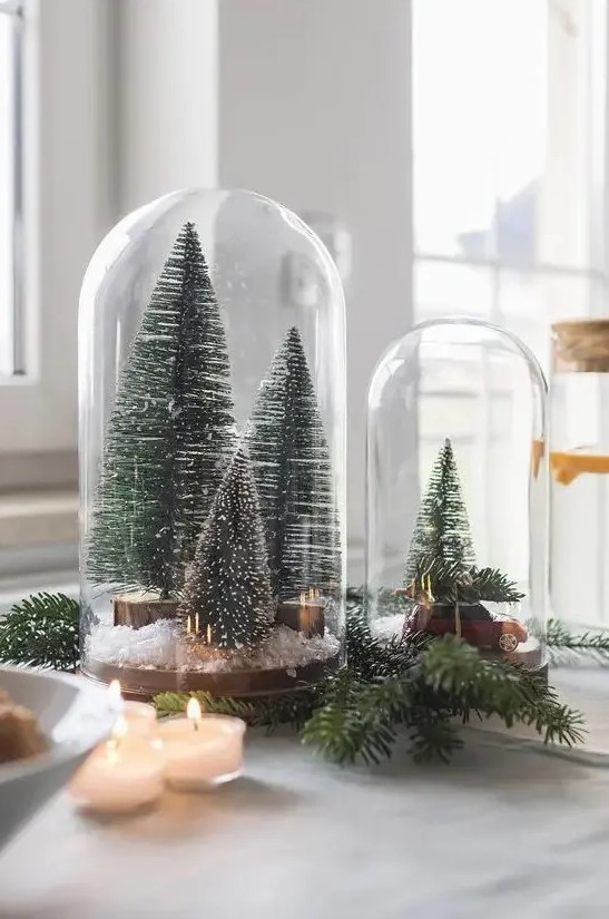 cloches with bottle brush Christmas trees, faux snow and a small car are amazing for holiday styling