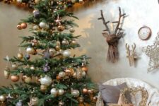 copper, gold and pearl Christmas decor with lots of ornaments looks refined and perfectly matches woodland Christmas decor theme