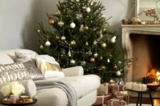 copper, silver and gold ornaments of various shapes make the tree very chic and don’t require any additional decor here