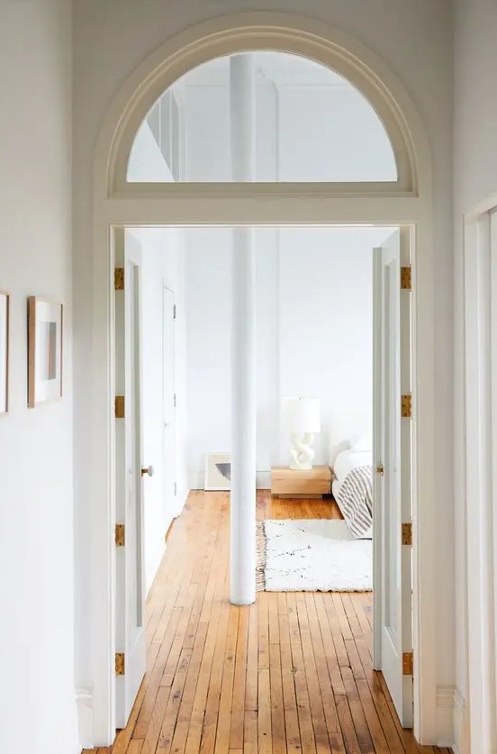 doors paired with an arched transom window look very stylish and chic and add to the decor of the space