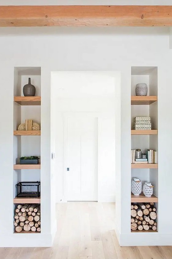long and narrow niches with wooden shelves inside add decorative value to the space and show off some stuff inside