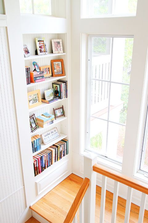 niche shelves built-in in the stairs are a great way to make use of this space and add decorative value to it