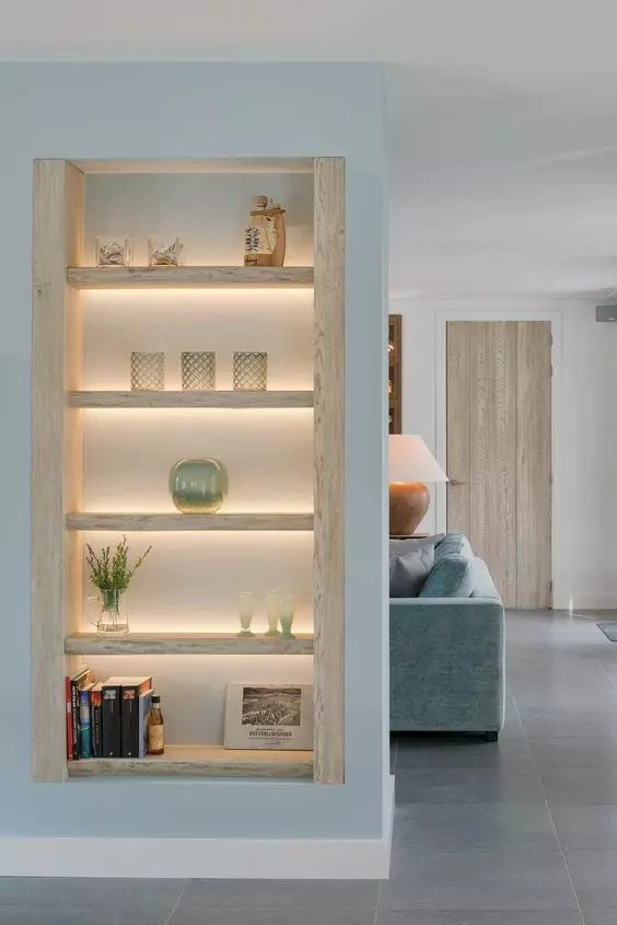 niche shelves of whitewashed wood and with built-in lights are amazing, and lights highlight everything that's on display