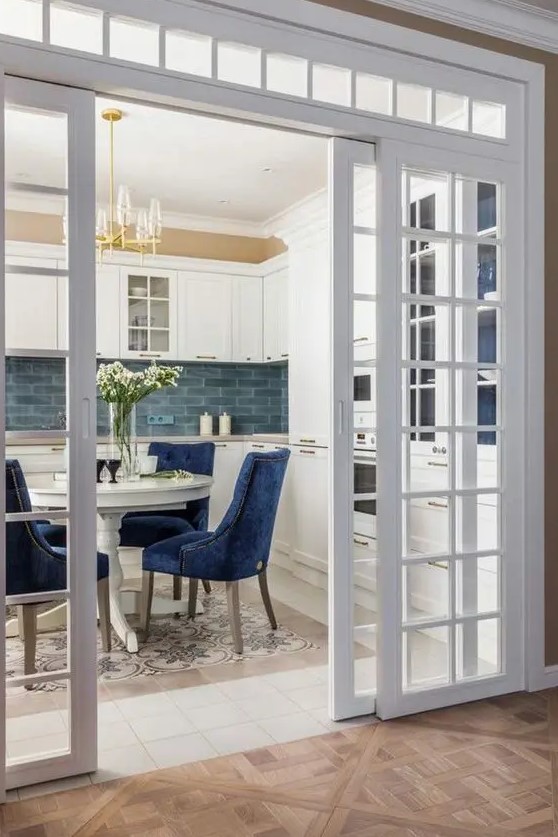 sliding French doors and a transom window are a great combo for a space, they look chic and beautiful and highlight the vintage style