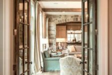vintage stained doors plus a transom window add coziness to the space and highlight the barn and farmhouse style of the house