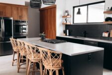 02 a beautiful black kitchen with a black skinny tile backsplash, white countertops, woven stools and lamps