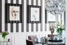 03 an exquisite dining room with a striped black and white wall, a chic shiny chandelier, lavender chairs and a mirror table