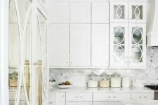 10 a gorgeous white kitchen with brass details and mirror and glass doors looks really luxurious
