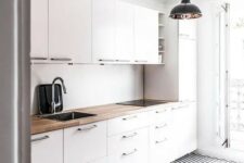 13 a modern white kitchen with a geometric floor and a wooden countertop to make it look more interesting