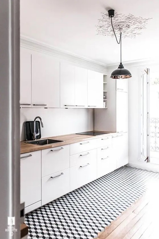 a modern white kitchen with a geometric floor and a wooden countertop to make it look more interesting