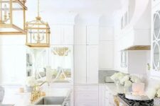 19 a chic and glam white kitchen with gold fixtures, refined gold pendant lamps and gold handles is a very beautiful and refined idea