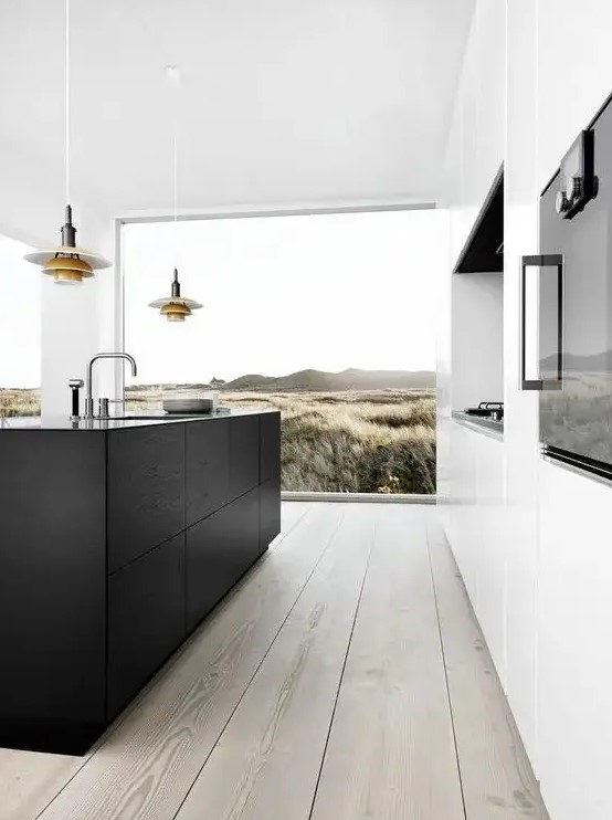 a contemporary kitchen with a niche for cooking, a black kitchen island, a glazed wall and cool pendant lamps over the island