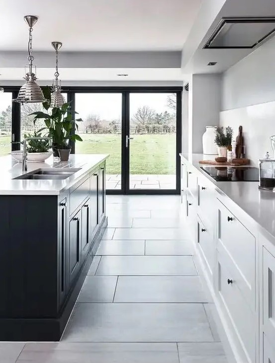 a contemporary kitchen with white cabinets and a black kitchen island plus the same countertops for both