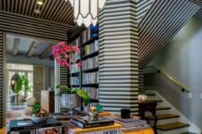 23 a super bold and eye-catchy space with black and white striped walls and a ceiling that create a mood in the space
