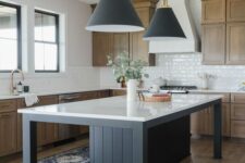 31 a modern rustic kitchen with timber cabinets, a white tile backsplash, a black kitchen island with a white countertop