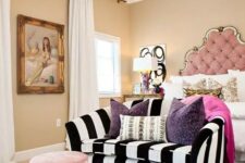 32 a refined and chic bedroom with tan walls, a pink bed with an extended headboard, a striped sofa and a pink pouf, a zebra printed rug