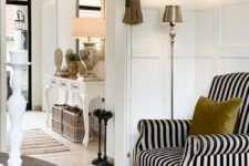 34 a sophisticated black and white striped chair with a mustard pillow is a gorgeous addition to the space