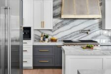 34 an art deco kitchen with grey and white cabinets, a metal hood, touches of gold and white marble countertops and a backsplash