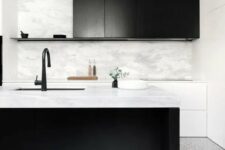 37 a stylish black and white kitchen with sleek white and black cabinets, a large kitchen island, black fixtures and greenery