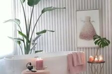 39 a charming girlish bathroom with a striped grey and white wall, a pink ottoman, a refined table and pink textiles