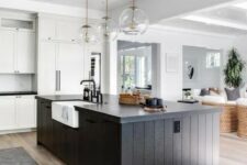39 a white kitchen with shaker cabinets, a black slatted kitchen island, glass sphere pendant lamps