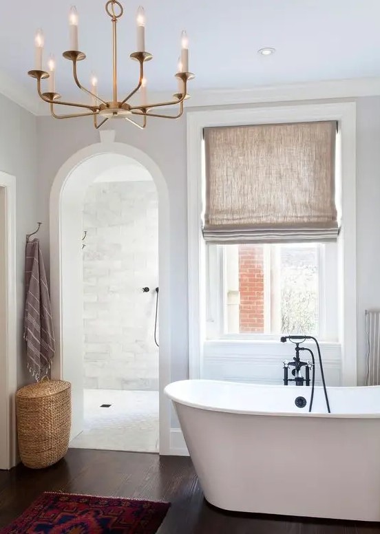 a contemporary bathroom with an arched doorway inviting to the shower space for more eye catchiness