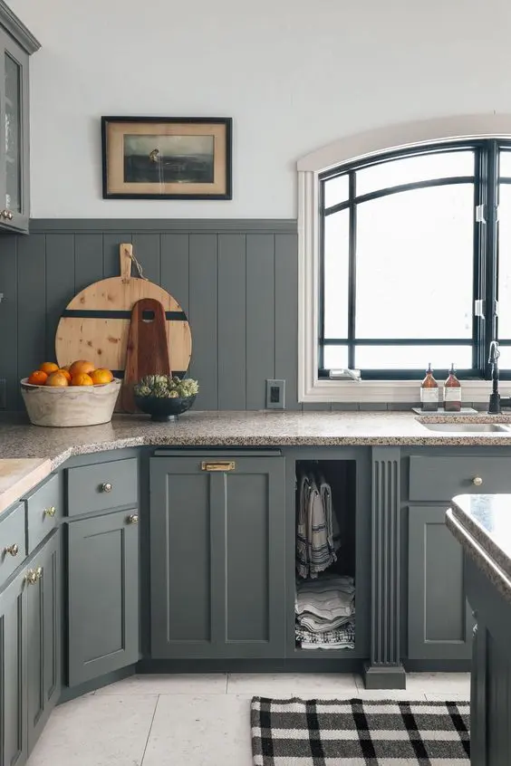 a beautiful vintage grey kitchen with shaker cabinets and a matching beadboard backsplash, a stone countertop