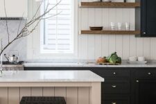 a contrasting kitchen with black cabinets, a neutral beadboard backsplash and a matching beadboard kitchen island