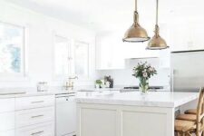 a farmhouse kitchen with brass vintage touches and marble countertops for an eye-catchy touch
