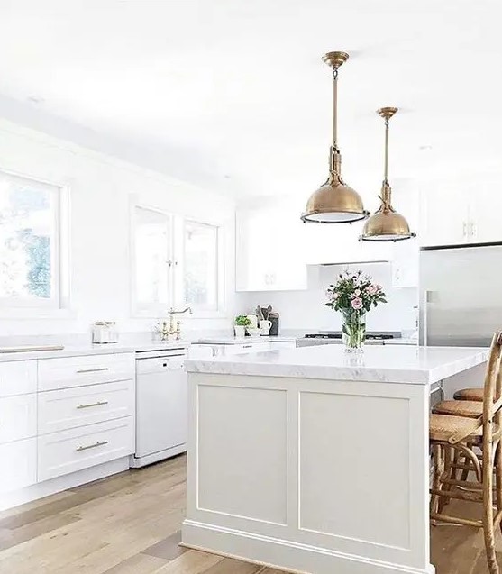 a farmhouse kitchen with brass vintage touches and marble countertops for an eye catchy touch