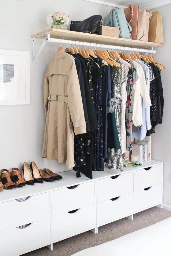 a makeshift closet with a shelf for bags and a long dresser for smaller things and accessories used for shoes, too