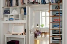 a makeshift closet with open storage units, shelves and a ladder to climb up to these things is a great idea for a bedroom with no space for a closet