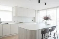 a stylish kitchen with marble backsplash
