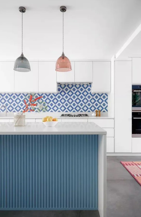a stylish kitchen with a geometric backsplash
