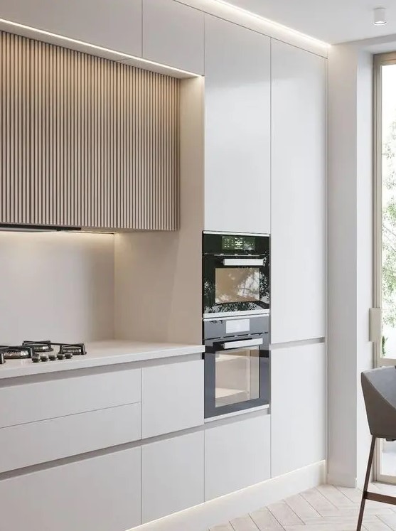 a minimalist white kitchen with sleek cabinets and light stained ribbed upper cabinets with lights is a lovely idea