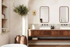 a modern country bathroom with white walls and a ceiling, a stained chevron floor, a stained vanity and arched niches is lovely