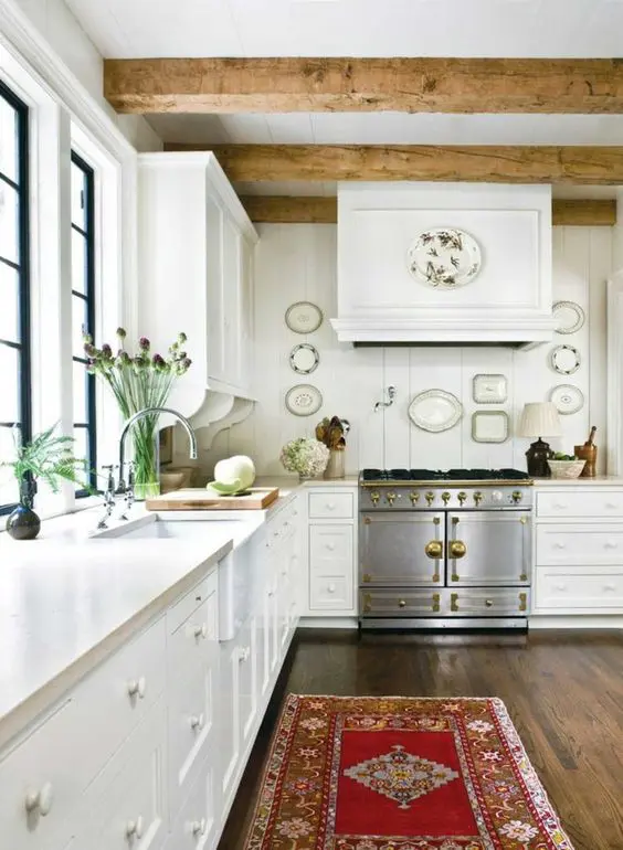 a neutral vintage kitchen with shaker cabinets, a matching beadboard backsplash, stone countertops and wooden beams