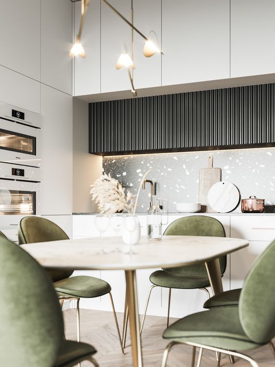 a refined contemporary kitchen with sleek neutral and black fluted cabinets, built in appliances, a table and green chairs