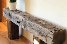 a rough wood console table or bench like this one will be an eye-catchy and lovely solution for a farmhouse space or just for a modern one