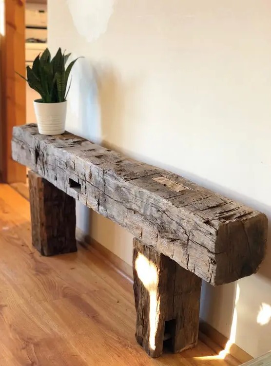 a rough wood console table or bench like this one will be an eye-catchy and lovely solution for a farmhouse space or just for a modern one