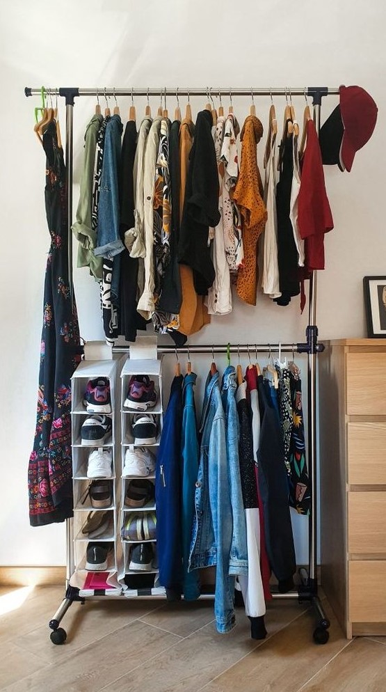 a simple makeshift closet with a double hanging shoe shelf and a dresser for small things next to it is a cool idea