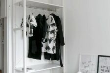 a small Scandinavian makeshift closet with shelves and a rack with clothes hangers plus a basket are great for those with a minimal wardrobe