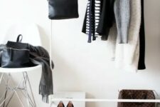a white makeshift closet and a stool are all you need for a small wardrobe, the space feels Scandinavian