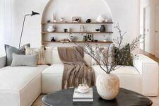 a stylish minimalist living room with an arched niche