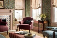 02 a catchy vintage living room with green floral wallpaper, a green sofa, burgundy chairs and a blue one, a plaid ottoman and a printed rug